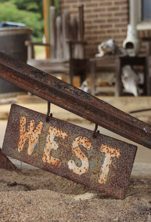 Metal Sign With Word West Outside of Rural Shop in Texasの写真素材