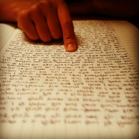 Focus on reading with finger has written manuscript text nepaliの素材