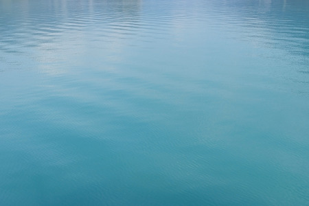 Clean and clear turquoise water in a lake in Switzerlandの写真素材