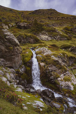 Waterfall on a moss-covered hillの写真素材
