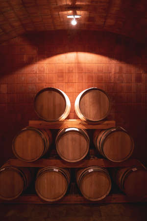 Wine barrel stacked on a shelf in the basement of a cellar.の写真素材
