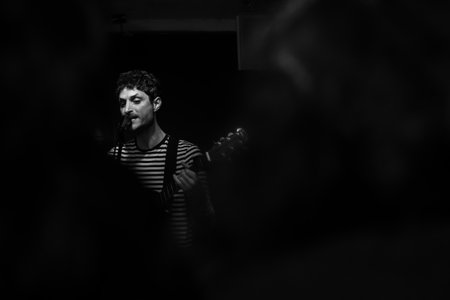 Musician playing guitar during a concertの写真素材