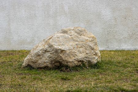 Granite stone mounted on green grass.Texture, material, builの写真素材
