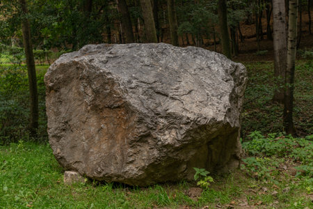 A large rock in the middle of the forest in a zoo in Slovakiaの写真素材