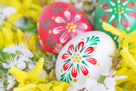 Easter eggs among spring flowersの写真素材