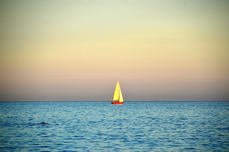 sailing boat at sunset photoの写真素材