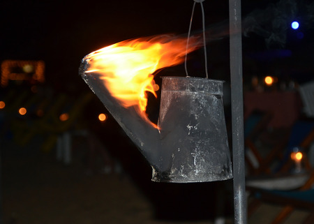 flaming torch created from watering can photography