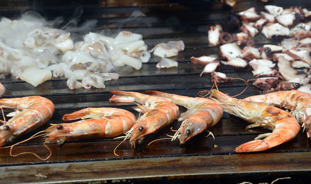 tiger prawns and calamari sea food on the grillの写真素材