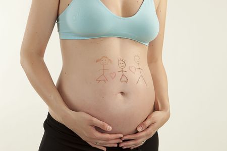 pregnant girl with drawing on belly on white backgroundの写真素材
