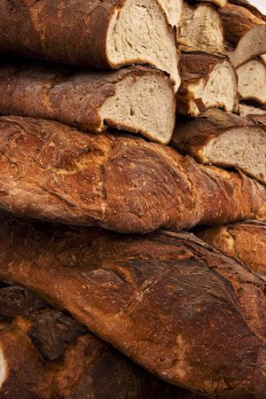Fresh Italian ciabatta cut bread and crust background.の写真素材