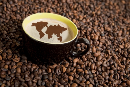 Coffee in coffee beans. World map in coffee foam.の写真素材