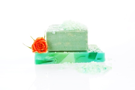 Wellness background. Organic soap bar with bath salt and rose isolated on white background.の写真素材