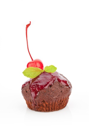 Delicious chocolate muffin with marmalade and cherry garnish isolated on white background.の写真素材