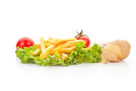 French fries with fresh salad, tomatoes, potatoes and ketchup. Culinary vegetarian eating.