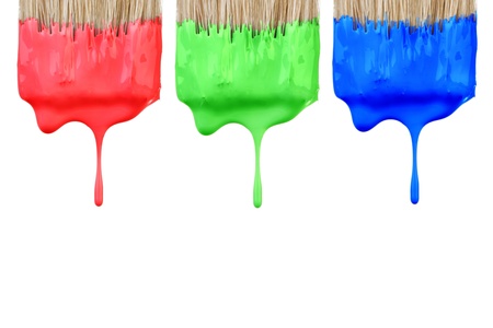Red, green and blue paint dropping from brush isolated on white background. Graphic design creativity concept.の写真素材