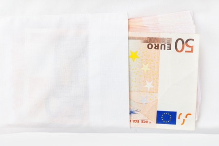 Fifty euro banknotes in white dress shirt pocket close up. Salary or corruption? Wealth or debt?