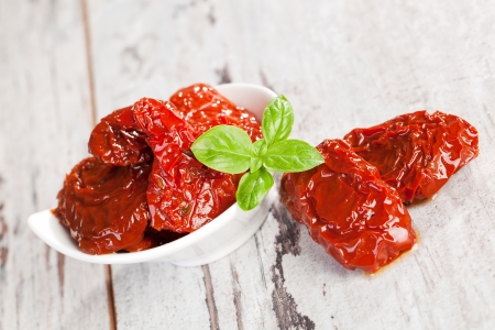 Delicious dried tomatoes on white textured wooden background  Culinary mediterranean eating の写真素材