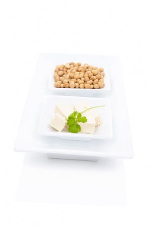 Tofu with green herbs and soybeans in white square bowl isolated on white background  Vegetarian   vegan eating  の写真素材