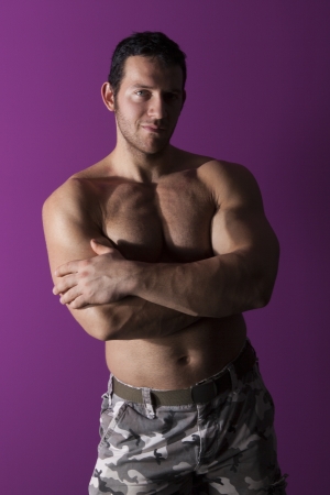 Sexy muscular shirtless bodybuilder smiling and looking into the camera isolated. Fitness is sexy.の写真素材