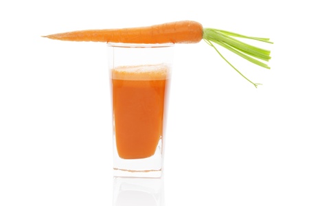 Carrot juice in glass with fresh carrot isolated on white background with reflection. Fresh lifestyle, healthy living.の写真素材