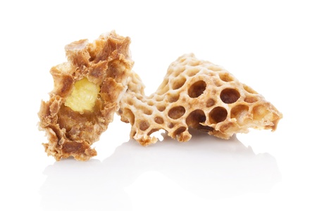 Royal jelly in honeycomb isolated on white background. Beauty and antiaging concept. Organic and...