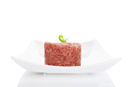 Luxurious tuna tartare on white plate isolated on white backgroundの写真素材