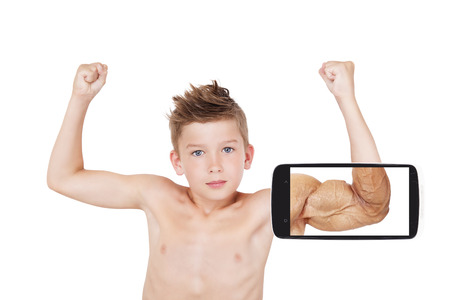 Vision of success. Charming boy showing muscle with future vision on smartphone screen. Seeing the future, self confidence and self perception.の写真素材