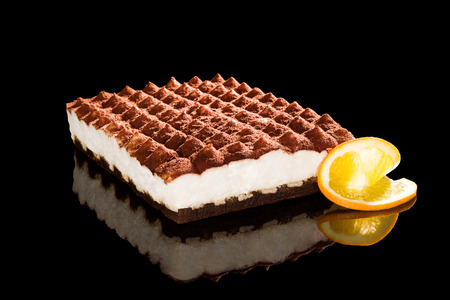 Delicious tiramisu dessert isolated on black background. Traditional sweet dessert.の写真素材