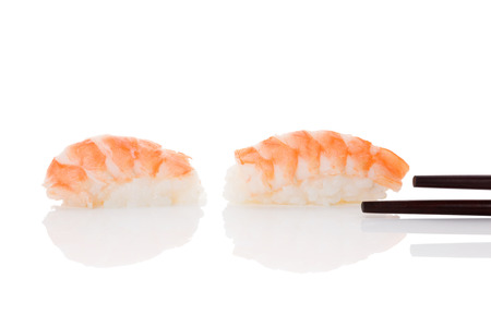 Delicious luxurious nigiri sushi with shrimp and chopsticks isolated on white background. Minimal contemporary asian style.の写真素材