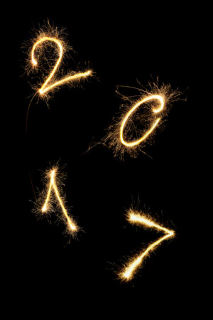 Happy new year. Digits 2017 made from fireworks isolated on black background. 