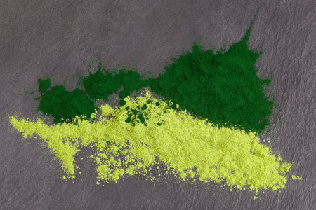 Adaptogen background. Ground powdered chlorella and barley top view. Superfood concept.の写真素材