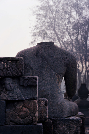 Buddha statue without a head in Borobudur, Indonesia, Asia.のeditorial素材