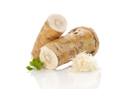 Horseradish root and grated horseradish isolated on white backgroundの写真素材