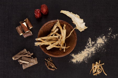Traditional medical herbs from asia, alternative medicine. Aswagadha, ginseng, raisin tre, jujube. Adaptogen background.の写真素材