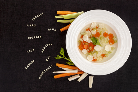 Healthy alphabet soup for kids. Lunch menu. Restaurant menu background concept. Words parsley, organic, food, eat carrot from alphabet noodles from above.の写真素材