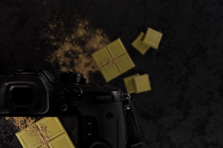 Food photography concept from above. Green hemp Chocolate with hemp flour on black table from above with camera in composition.の写真素材