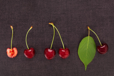 Healthy Red cherries on dark background from above. Flat lay, top view.