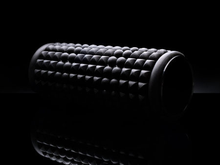 Foam roller on black background isolated.の写真素材