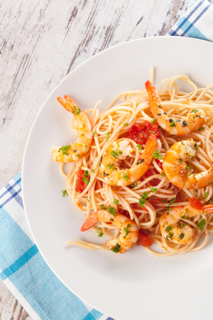 Spaghetti with shrimps on plate from above. Seafood eating concept.の写真素材