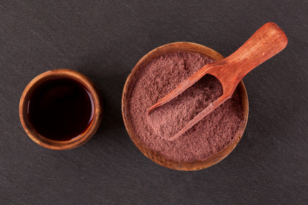 Ayahuasca brew and powdered mimosa tenuiflora in wooden bowls from above. Mimohuasca.の写真素材