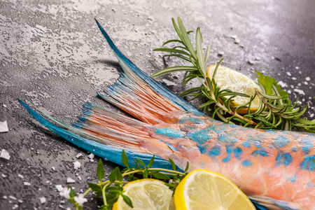 Fresh Parrotfish tail with lemons and herbs. Delicious healthy seafood eating.の写真素材