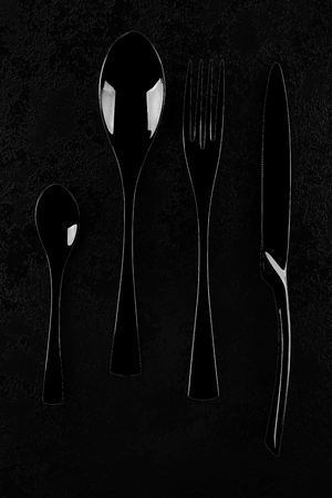 Black cutlery on black table, top view with clipping path.の写真素材