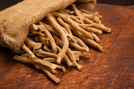 Aswagandha root on wooden table. Herbal adaptogen medicine.の写真素材