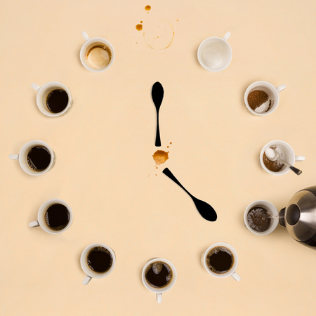 Cups of coffee making the shape of a clock. Caffeine addition.の写真素材