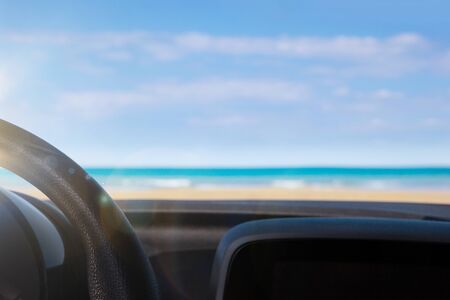 Beach and ocean viewed from inside a car. Road trip, freedom and camping.の写真素材