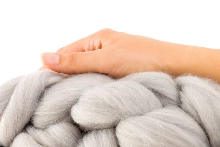 Young woman holding merino wool. Handmade chunky knitting. Winter fashion lifestyle.