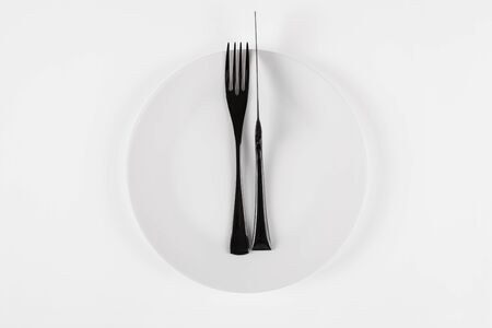 Cutlery language, dining etiquette. Excellent food. White ceramic round plate with knife anf fork...