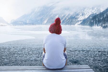 Handsome man in shorts on frozen lake. Winter ice swimming, cold expusure, healthy lifestyle.の写真素材