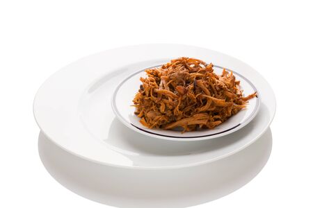 Traditional barbecue pulled pork on plate isolated on white background. Culinary meat eating.