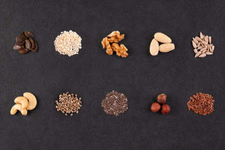 Various seeds and nuts on table. Flax, hemp, sunflower, sesame, chia, pumpkin seeds, and cashew, almond walnuts. Essential nutrients, omega-3 fatty acids. Superfoods.の写真素材